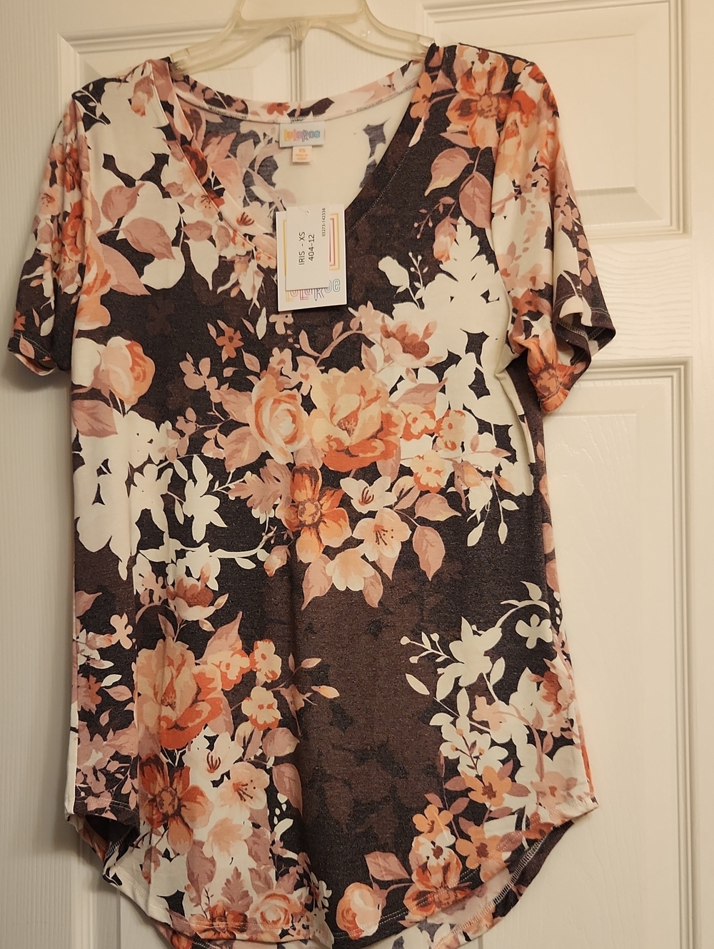 LuLaRoe Iris Short Sleeve Floral V-Neck Tee in Peach and Cream on Deep Purple